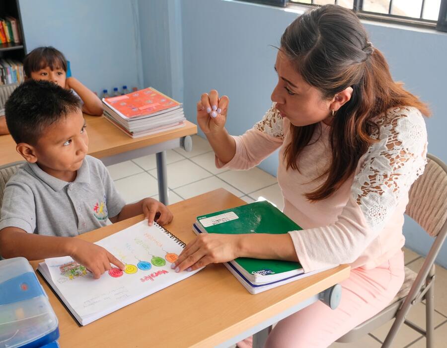 Guru mendampingi murid SD belajar