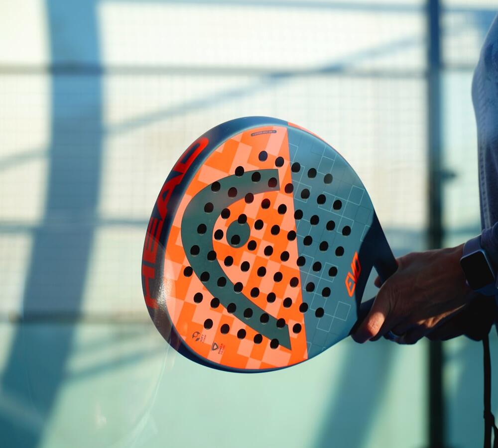 Raket padel di atas lapangan biru